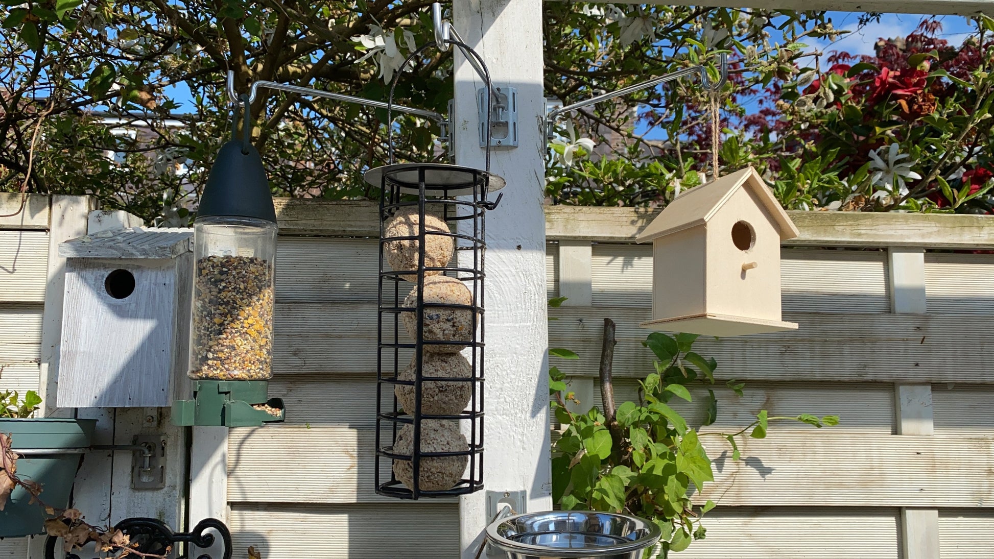 Image showing fence bird feeder hanger bar with bracket. Hanger bar has a hooked end to securely retain the feeders etc. Image shows a set 3 pack which can be fitted to fences, pergolas and walls with screw fittings provided in seconds - 3 Pack for £6.99 from potmagic.co.uk. Brackets are made from strong galvanised steel. Hook-ended hanger bar is made from strong 6mm diameter shiny galvanised steel. 