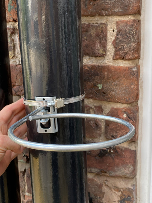 Image shows the WOW Plant Pot Holder by PotMagic. Fits any post from 50mm to 180mm DIA. Also has Adjustable Plant Pot Size Ring 4-7 inches. Price £5.99. Pot holding ring angle is also able to pivot through approximately 180 degrees to suit appearance. Contains 1 Plant Pot Holder , 1 ring bracket, and 1 adjustable lockable 50mm to 180mm jubilee clip. 